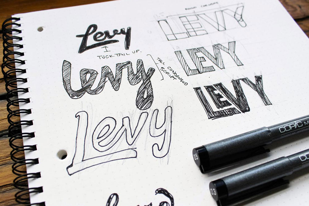 Image of sketchbook of logos for Levy
